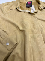 Close up of mustard suede button down shirt showing hidden buttons
