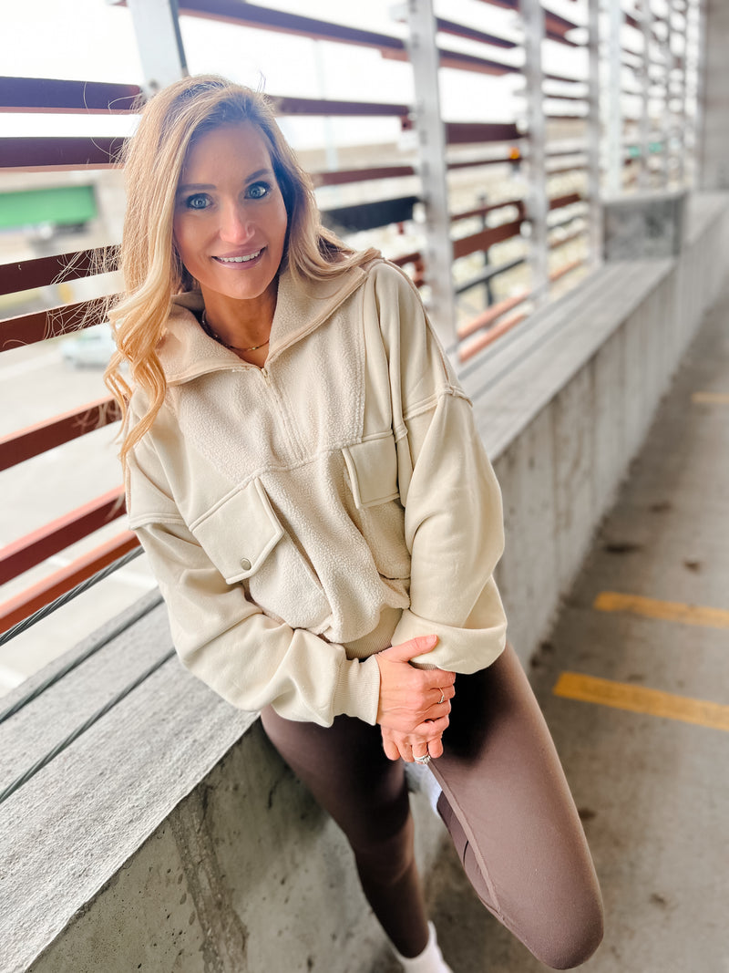 AEMI & CO quarter zip with oversized front pockets in cream