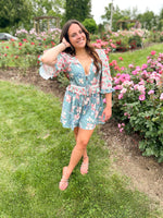 teal and pink mixed floral pattern romper with deep plunge