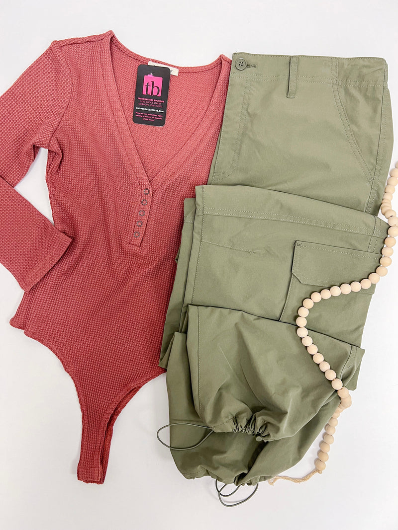 Dark mauve body suit with 3/4 sleeves paired with army green pants