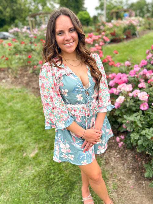 teal and pink mixed floral pattern romper with deep plunge