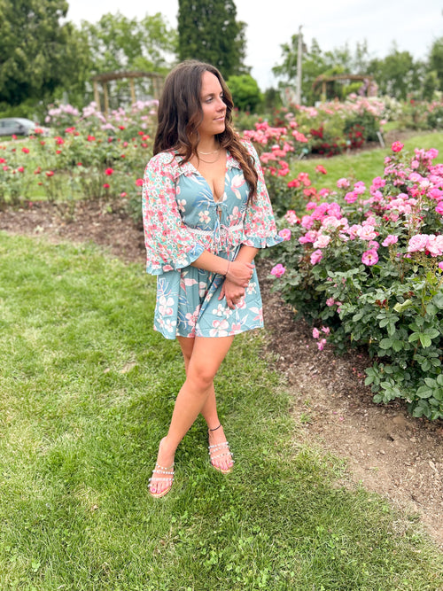 teal and pink mixed floral pattern romper with deep plunge