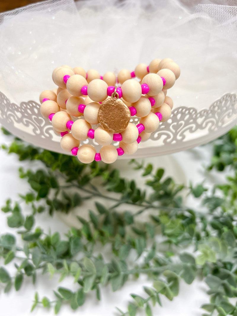 fuchsia wood bead stretch bracelet set with charm detail 