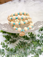 mint wood bead stretch bracelet with charm detail 
