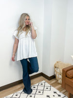 off white babydoll style top with swiss dot pattern and ladder cut out detail 
