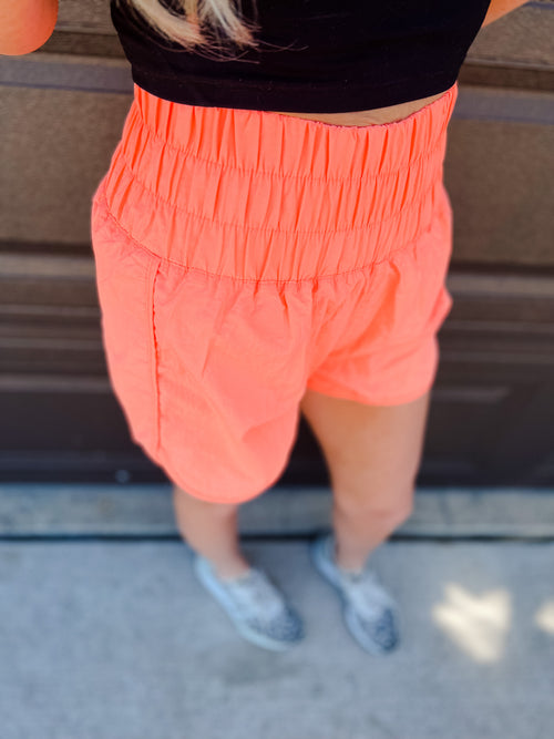 Neon Coral Smocked Windbreaker running shorts