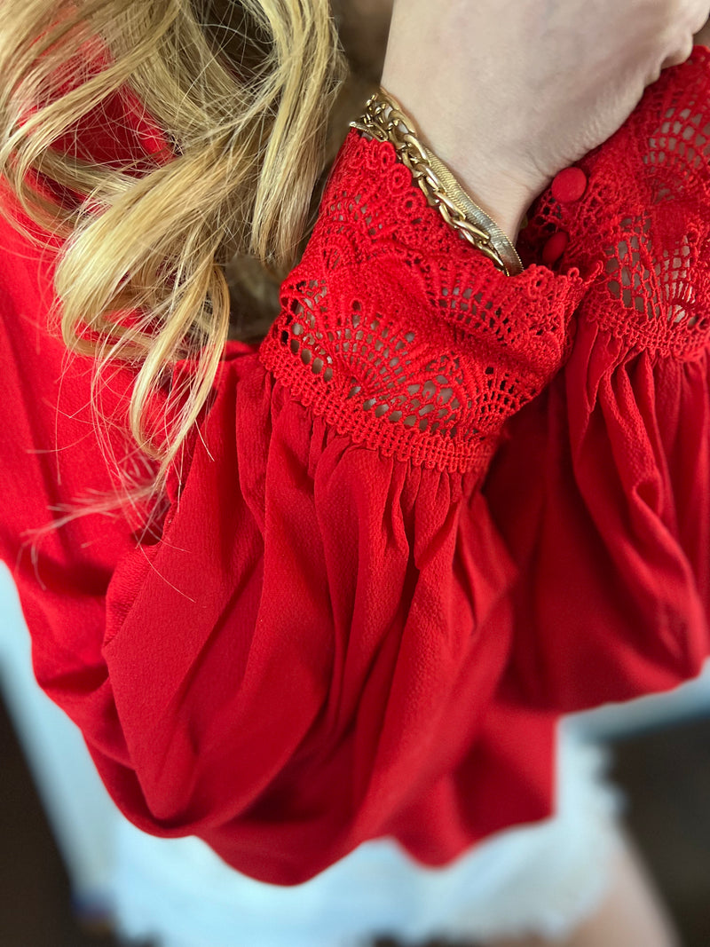 Red  V-neck blouse with bishop sleeves and wrist lace trim