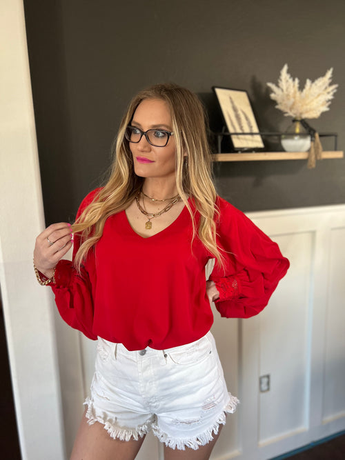 Red  V-neck blouse with bishop sleeves and wrist lace trim